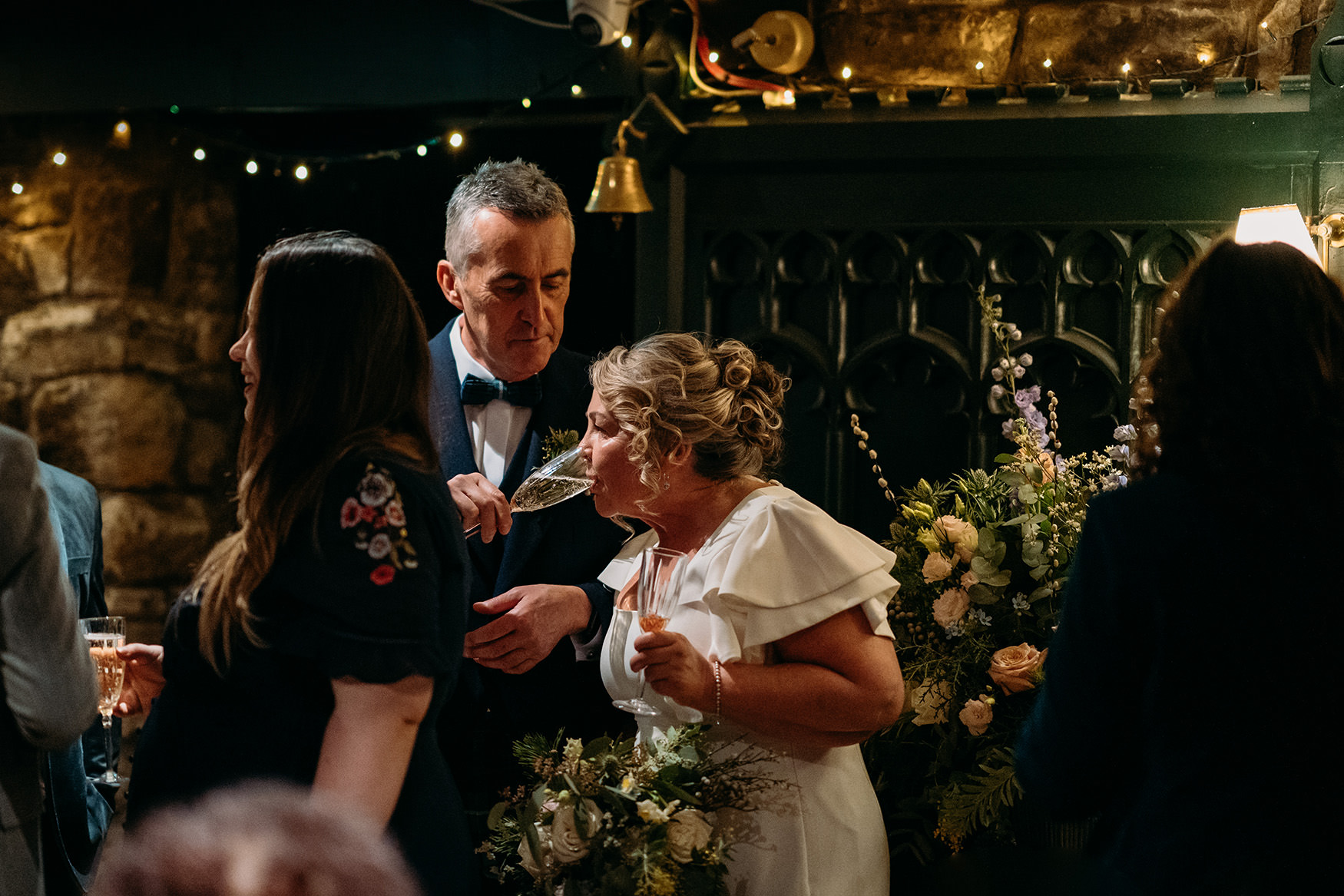 Groom shares champagne with bride at Glasgow micro wedding at The Buttery