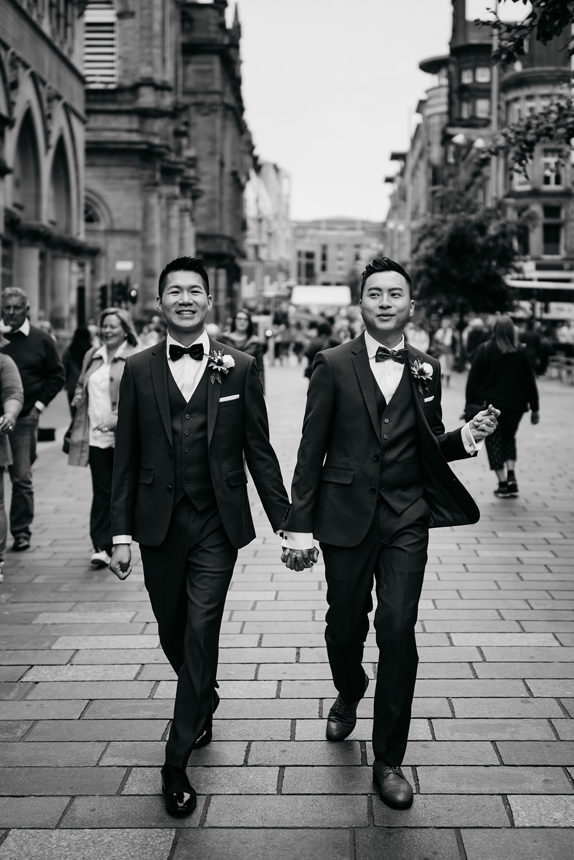 Two grooms walking down the street during their Glasgow micro wedding