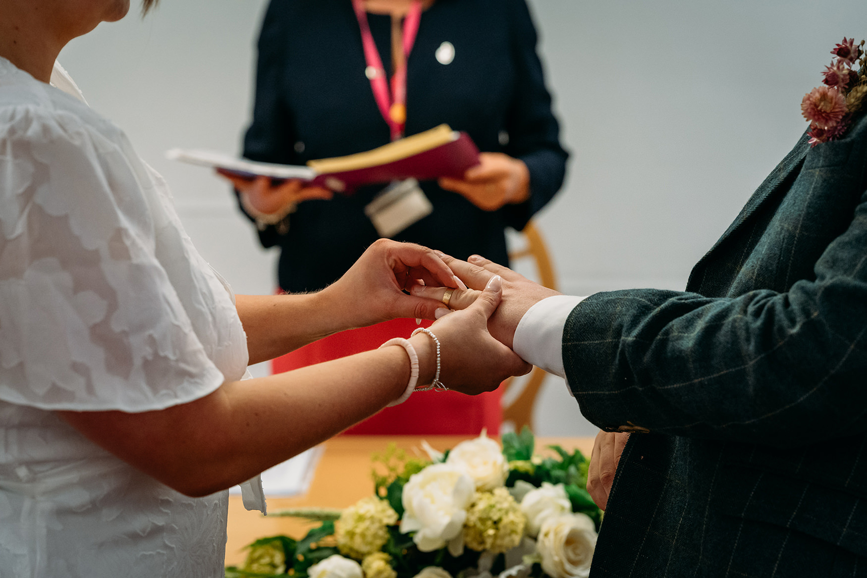 closeup of bride and grooms hands during ring exchange at Paisley registry office wedding