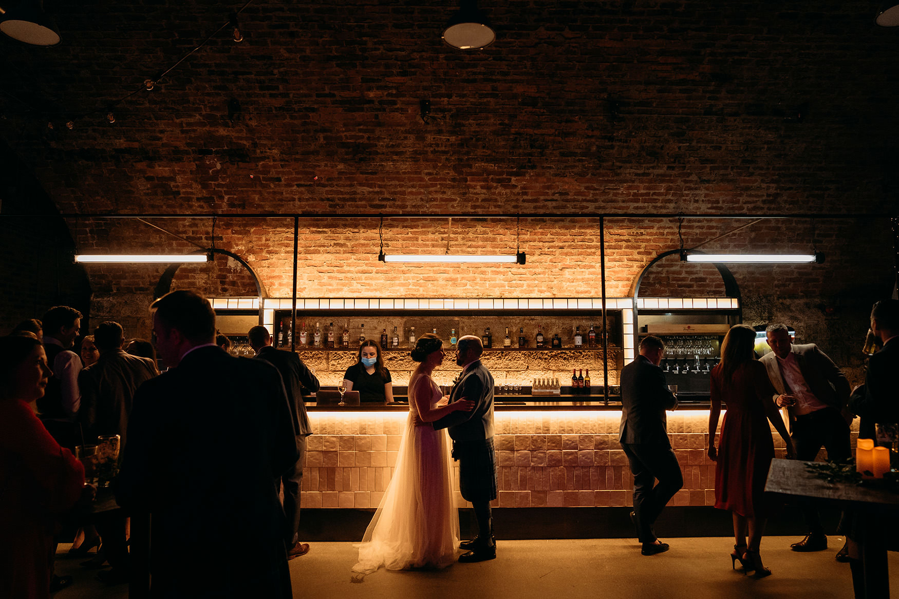 newlyweds share moment at the bar at Platform Glasgow wedding