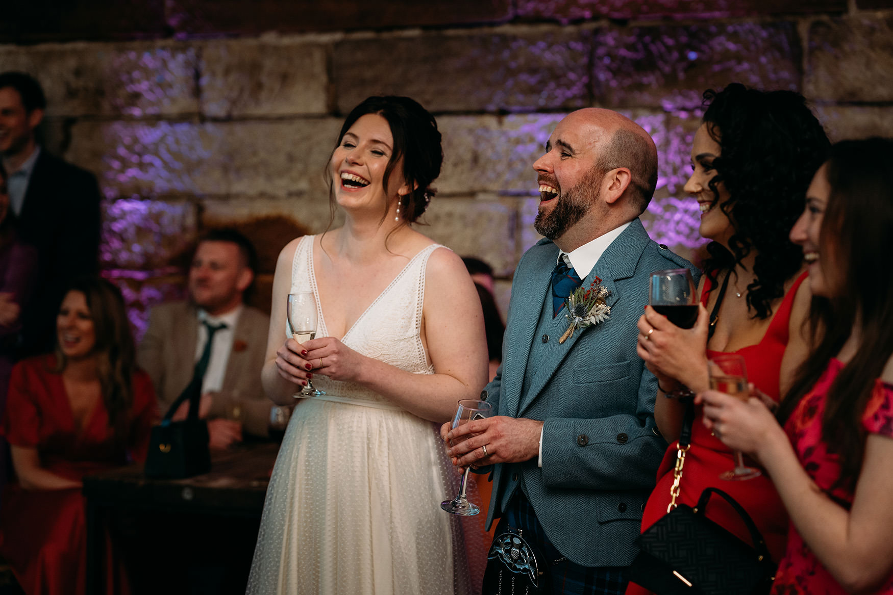 newlyweds laugh during Platform Glasgow wedding speeches