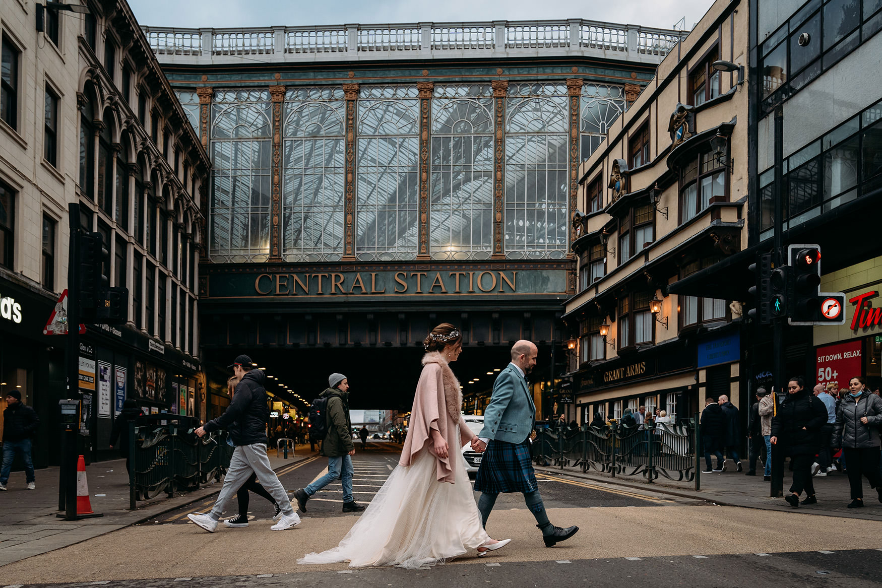 newlyweds cross road in front of central station during their Platform Glasgow wedding