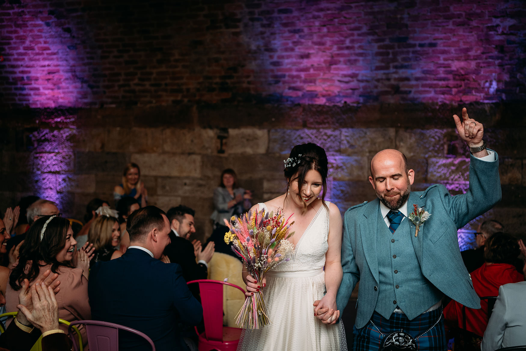 delighted newlyweds leaving their Platform Glasgow wedding ceremony