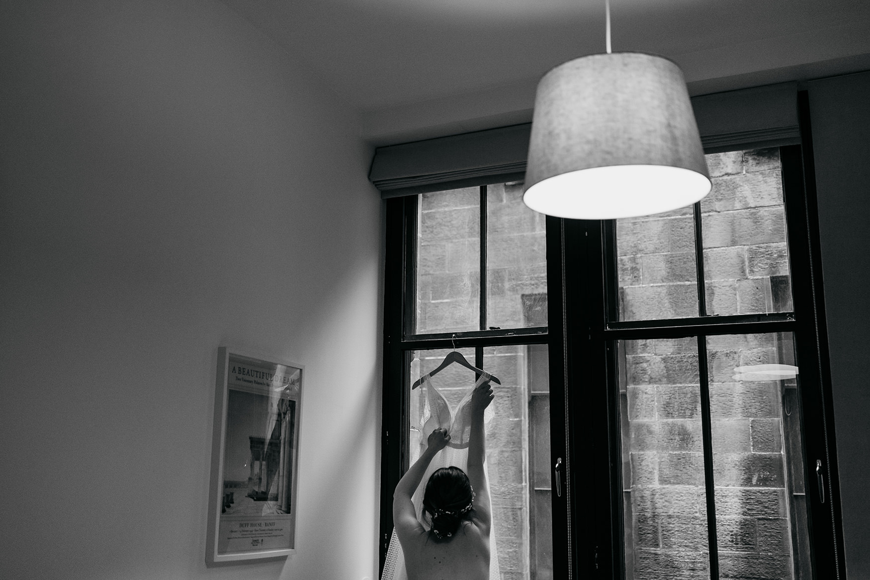 Bride reaches for her dress ahead of a Platform Glasgow wedding