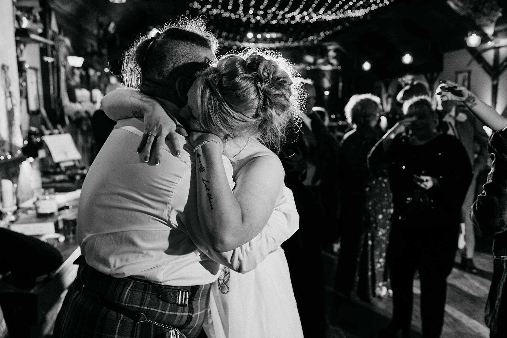 black and white photograph of newlyweds hugging at The Gathering at Woodhead Farm