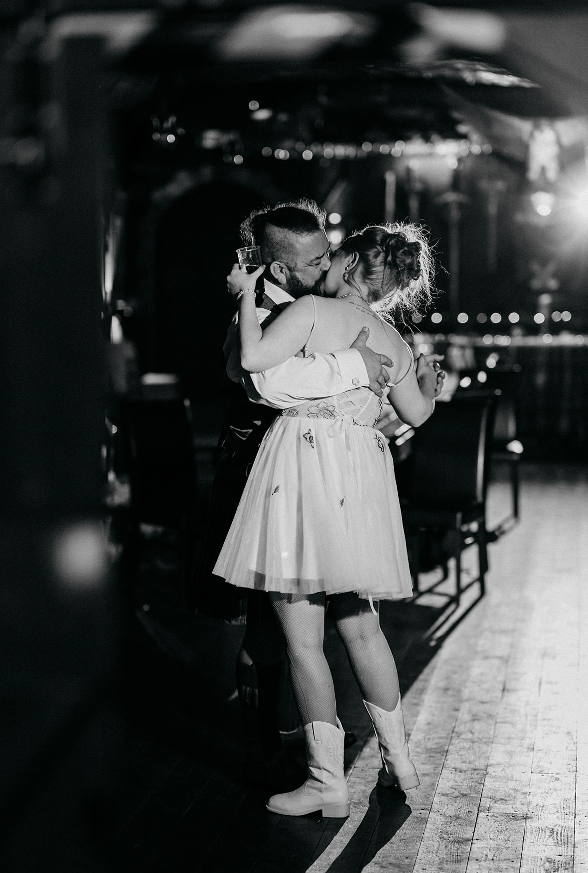 Groom kisses bride at their wedding at The Gathering at Woodhead Farm