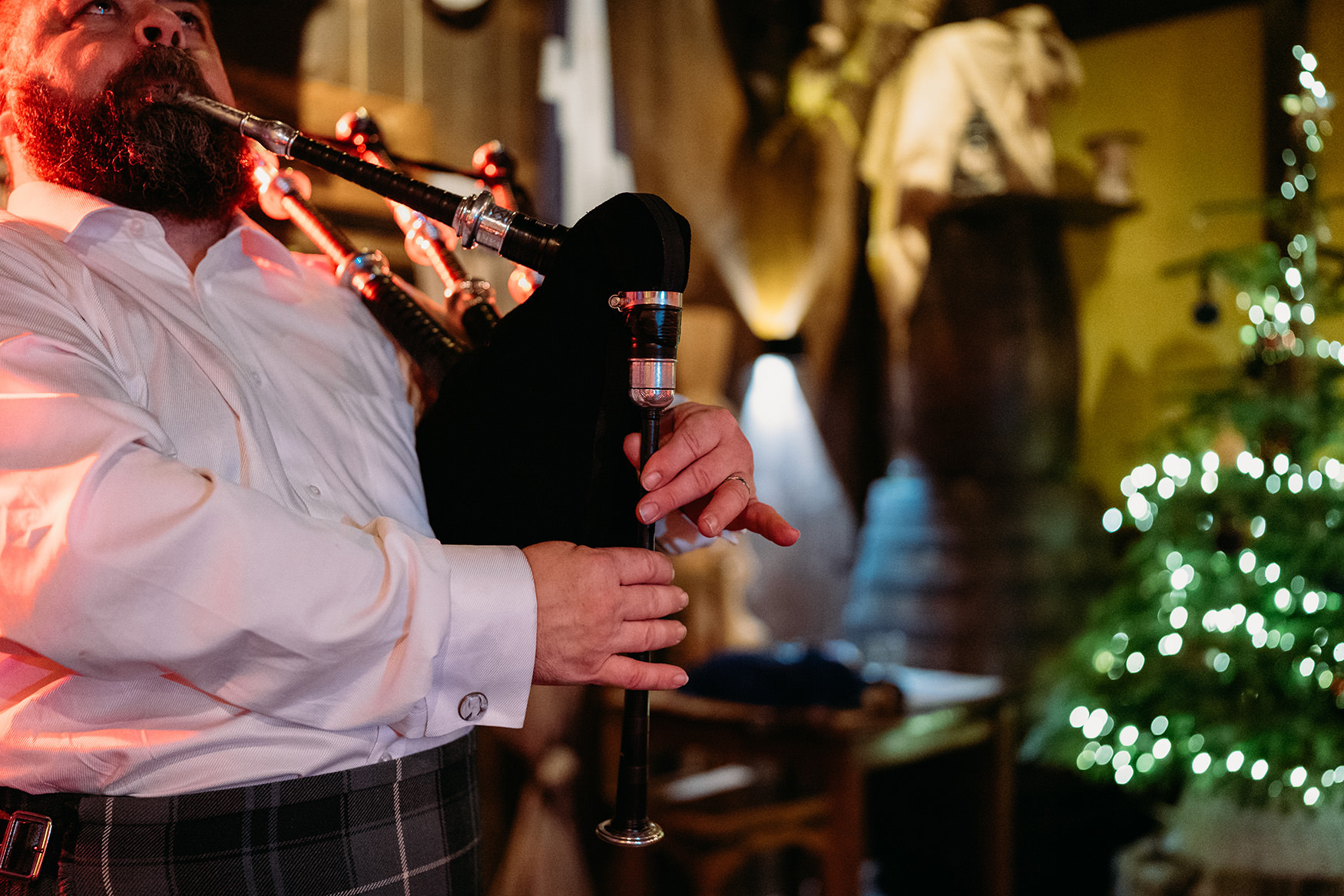 Groom piping on New Years Eve at The Gathering at Woodhead Farm wedding