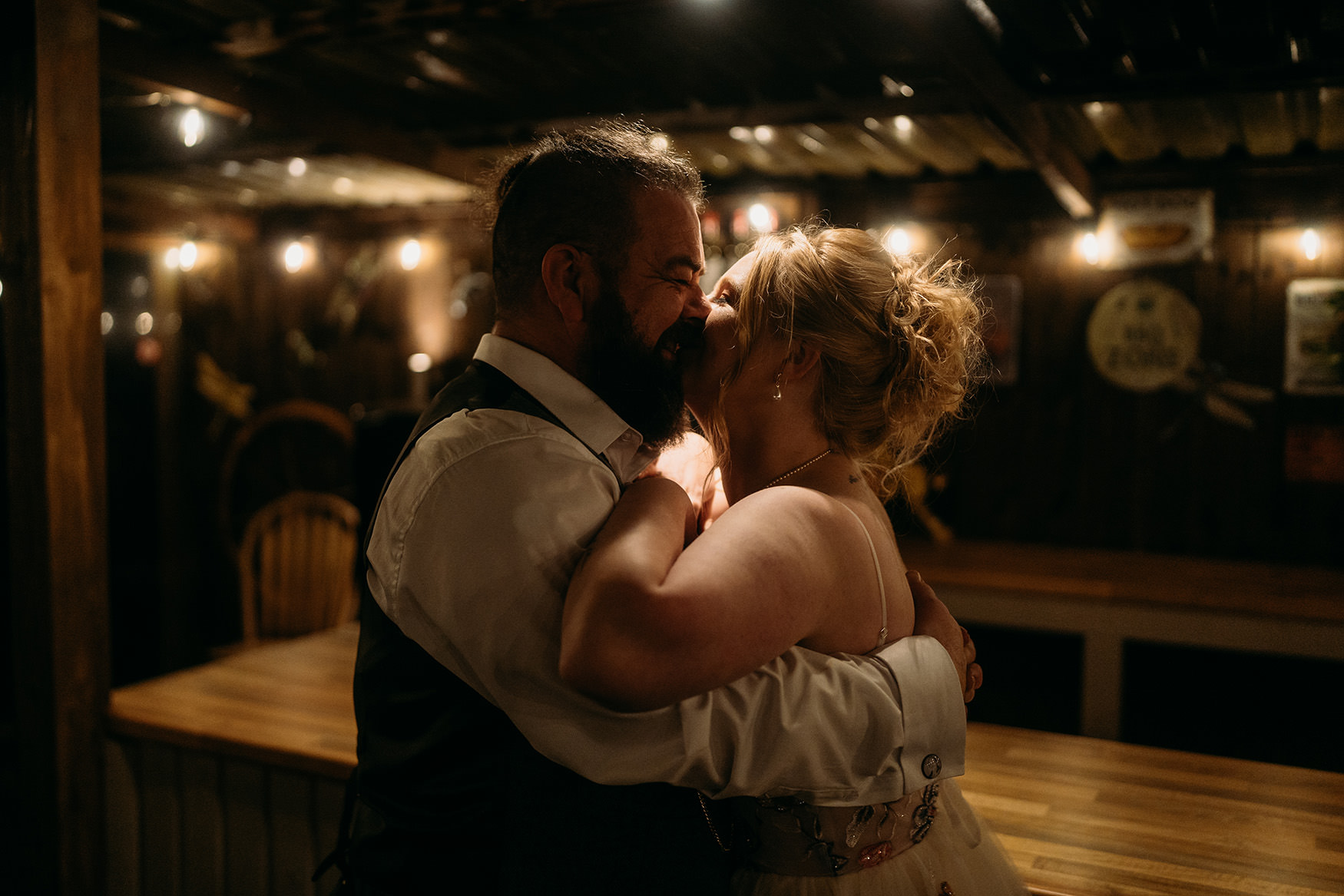 bride and groom kiss outside The Gathering at Woodhead Farm