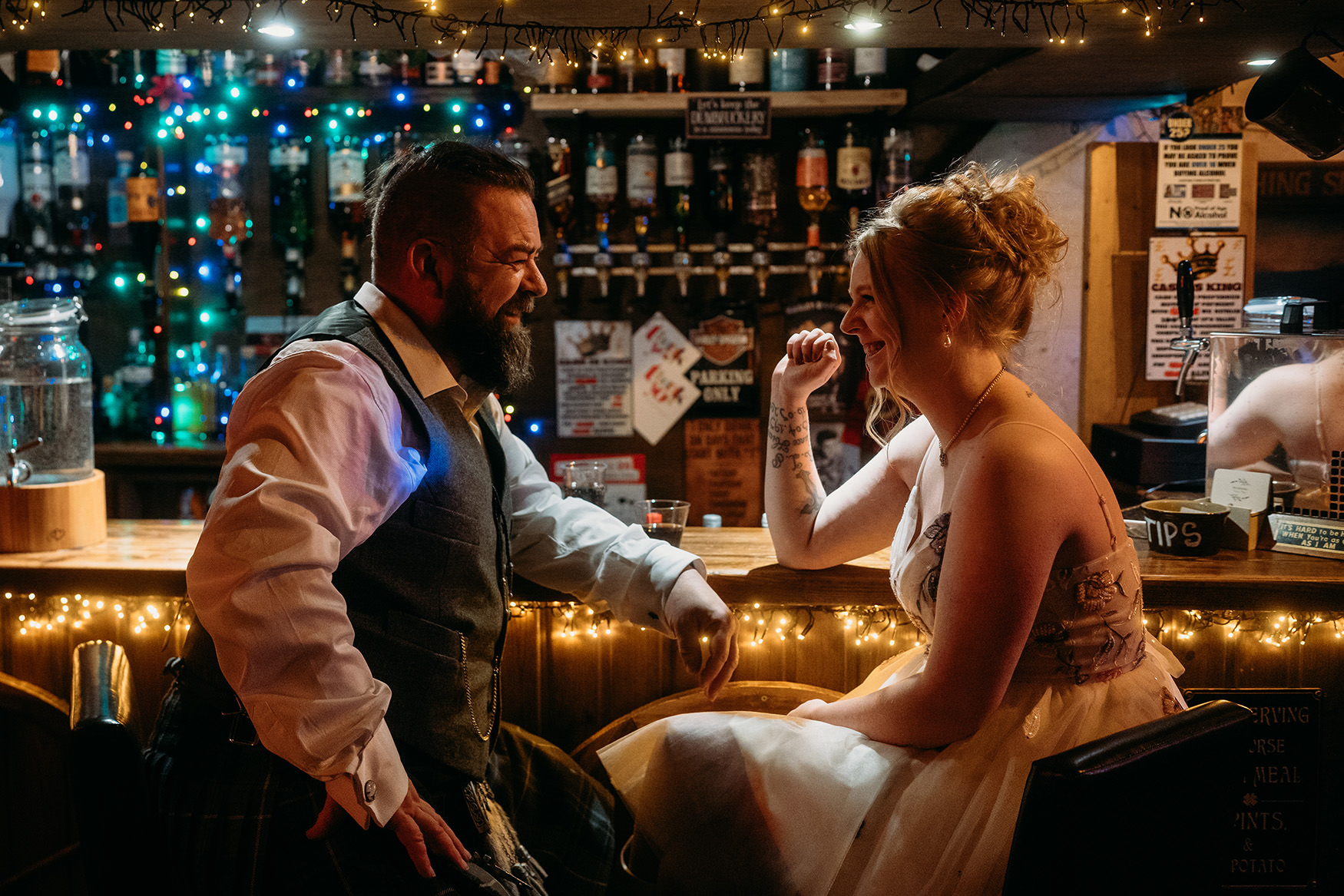 bride and groom at the bar on their wedding day at The Gathering at Woodhead Farm