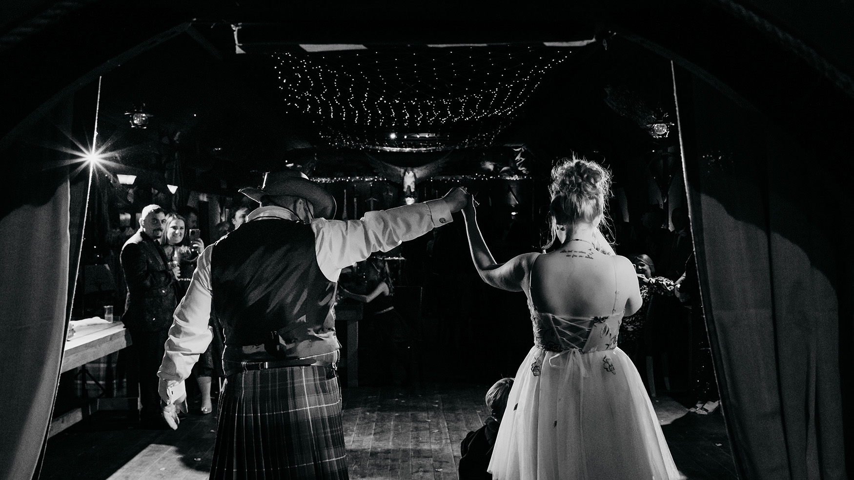 bride and groom walk onto dancefloor at their The Gathering at Woodhead Farm wedding