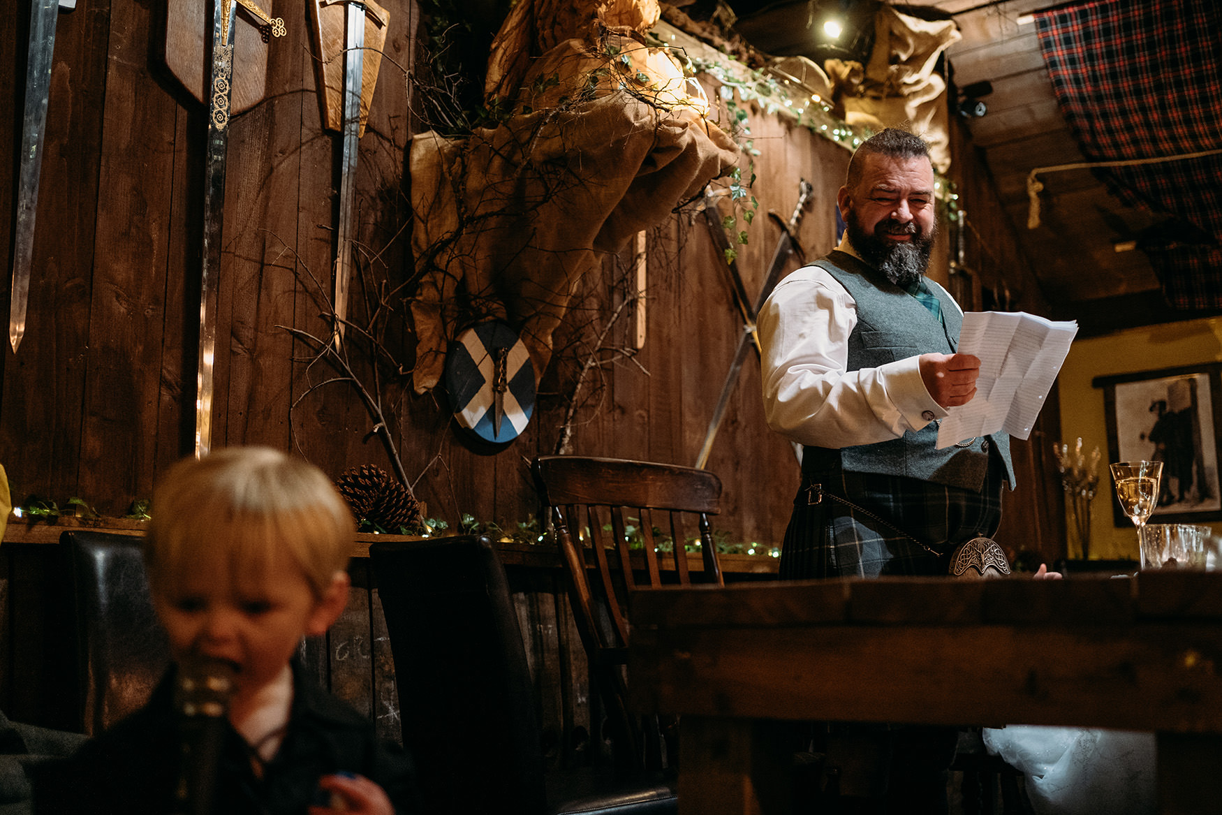 Groom looks lovingly at his son during his The Gathering at Woodhead Farm wedding